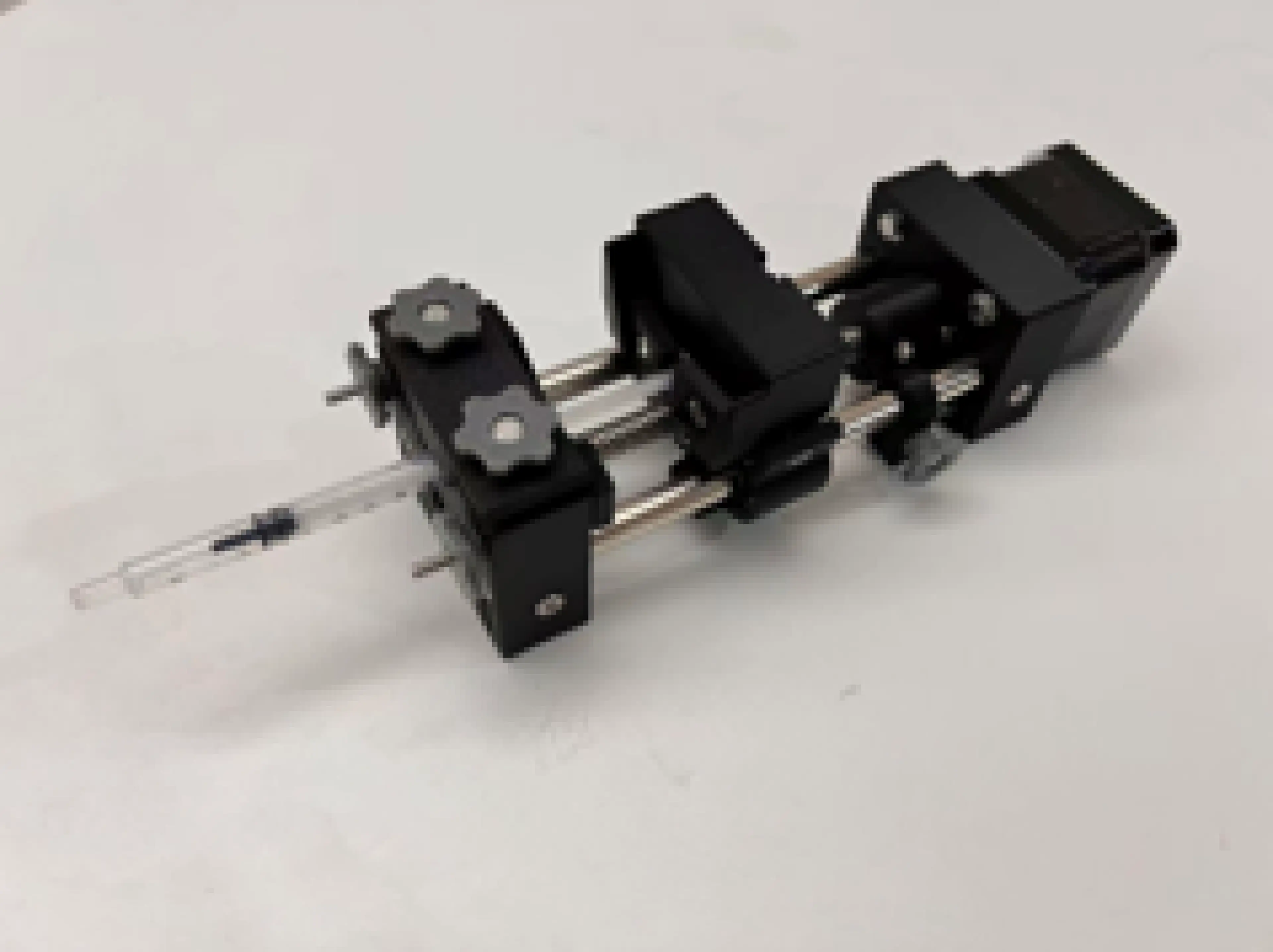 Close-up photograph of a compact motor-driven linear translation mechanism